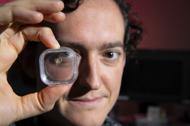 Dr Luke Daly, Research Associate in Solar System Science at the University of Glasgow’s School of Geographical and Earth Sciences, holding a piece of a Martian nakhlite meteorite.