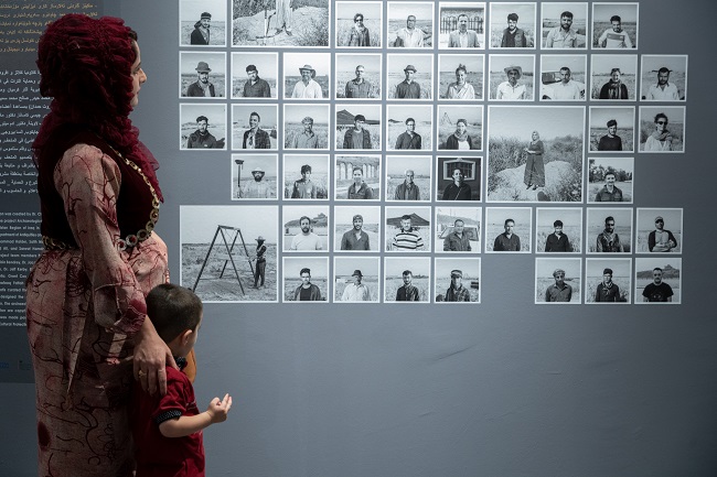 A photo of a mother and child in a new museum space created in Iraq in conjunction with University of Glasgow archaeologists