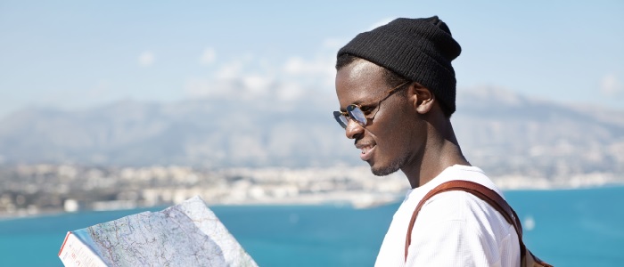 Student studying a map in a nice destination