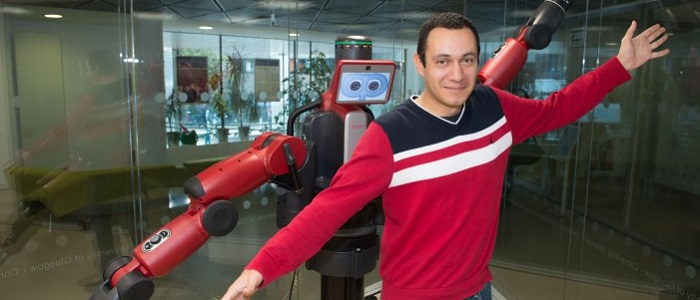 Member of staff demonstrating the Baxter Robot