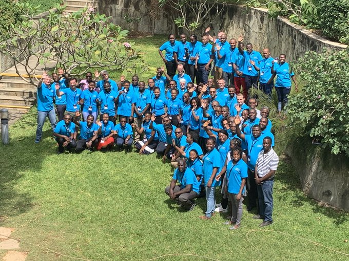 AfrIBOP participants wearing special t-shirts stand together in the shape of the African continent