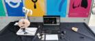 A photo of the petrous apex exhibit at an IUS 2019 public engagement event. On a table is a Phacon head used to train surgeons to carry out operations, the laptop that gives different viewing angles, and the ultrasound needle developed to do biopsy of the petrous apex.