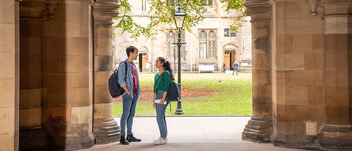 Two students in archway on campus 