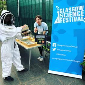 Photograph showing a GSF in Action student in a beekeepers suit with beekeeping essentials.