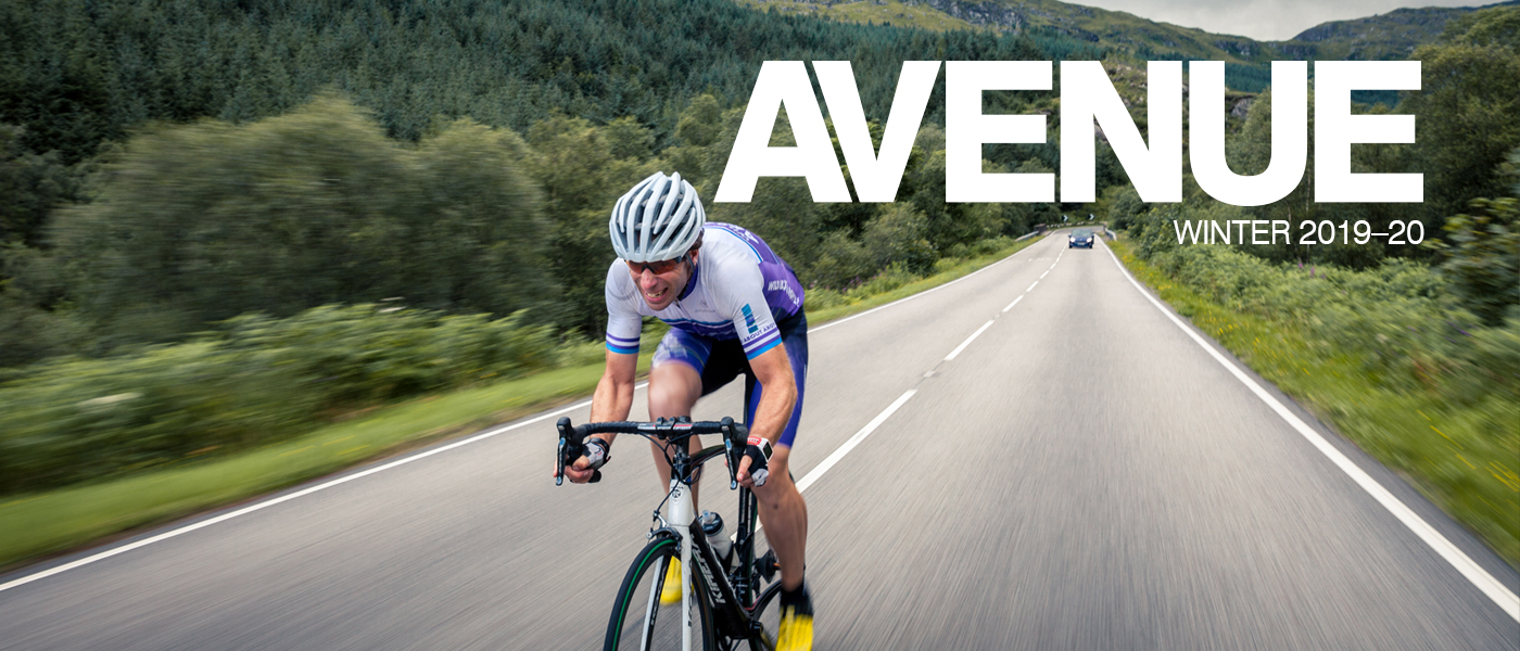 Mark Beaumont riding a bicycle along a road