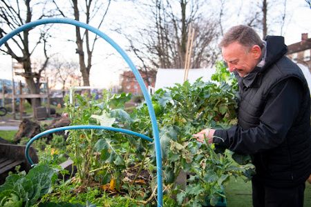 Picture of Alastair McCall tending to the garden at Baltic Street Adventure Playground