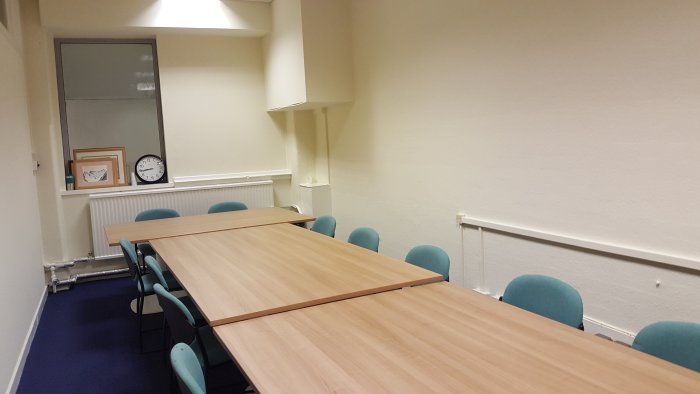 Flat floored meeting room with tables and chairs