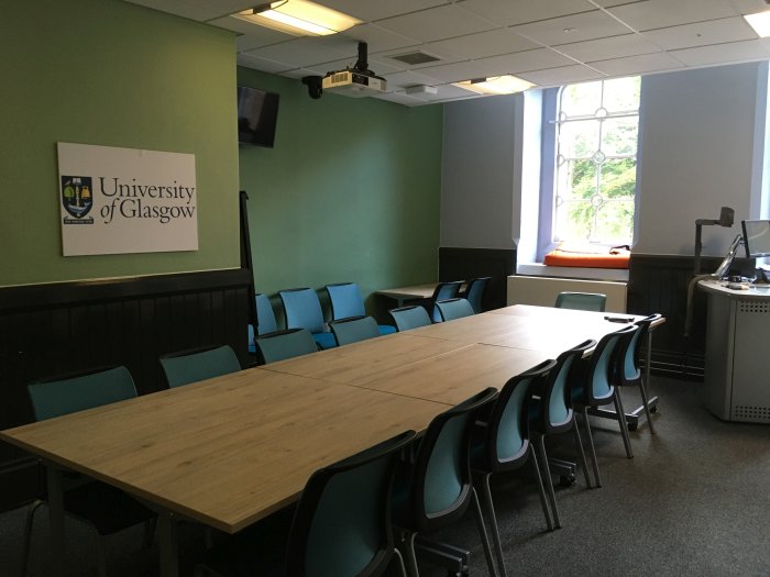 Flat floored meeting room with boardroom tables and chairs