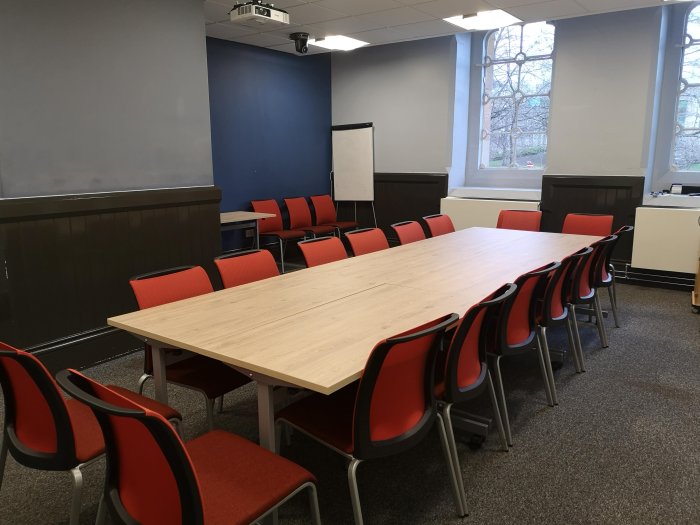 Flat floored meeting room with boardroom table and chairs