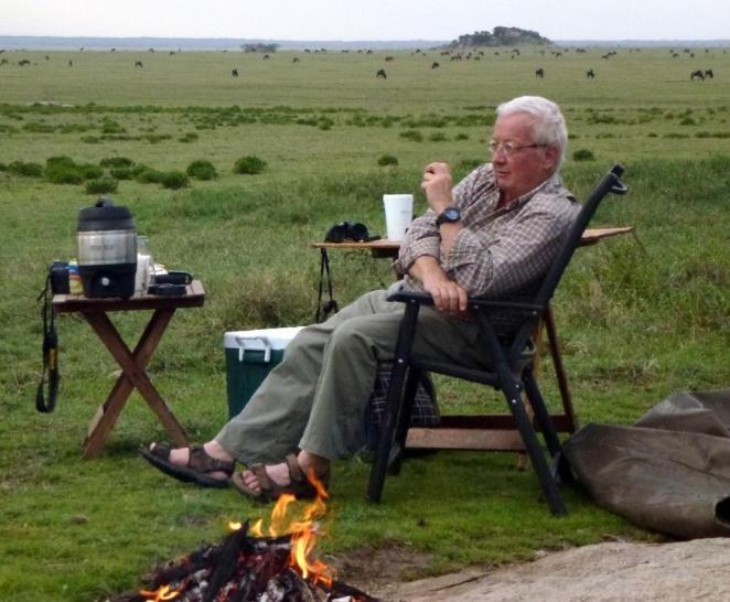 Markus Borner sitting by campfire