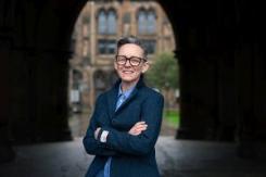 Photograph of Dr Amanda Sykes holding a UofG sign