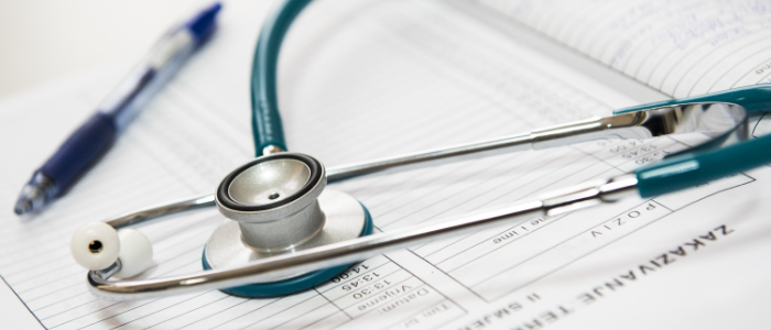 abstract photo of clipboard, stethoscope and pen