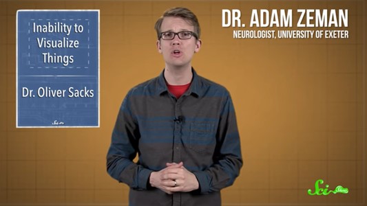 screenshot of a youtube video: torso of a middle-aged white man with fair hair and dark square glasses, caught mid-speech. a blue title-card reads 'Inability to visualise things. Dr Oliver Sacks' while of the other side of the man white floating text reads 'Dr adam zeman, neurologist, university of exeter'