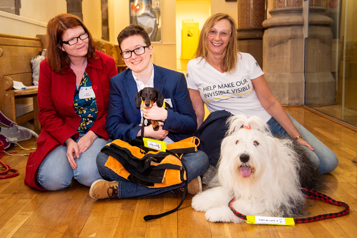 Attendees and dogs at invisible disabilities event May 2019