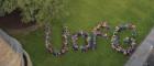 Aerial Image of people forming into the words UofG