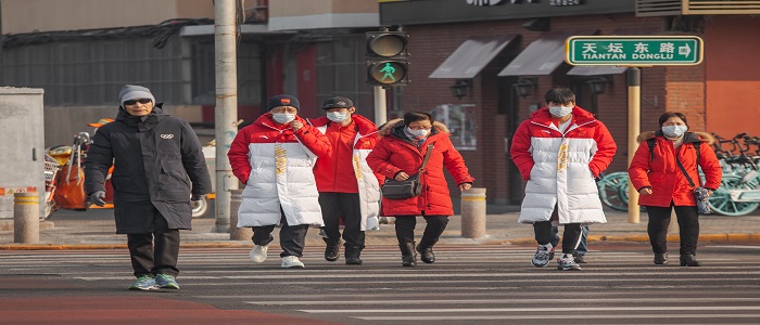 People in masks crossing Chinese street