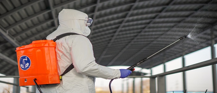 Person in PPE cleaning