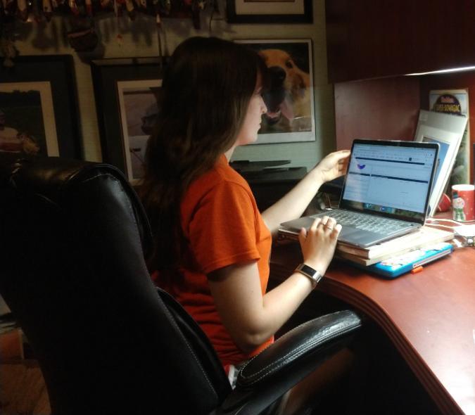 Student Katie Schmierbach, sat at her desk, working on the exam helpdesk