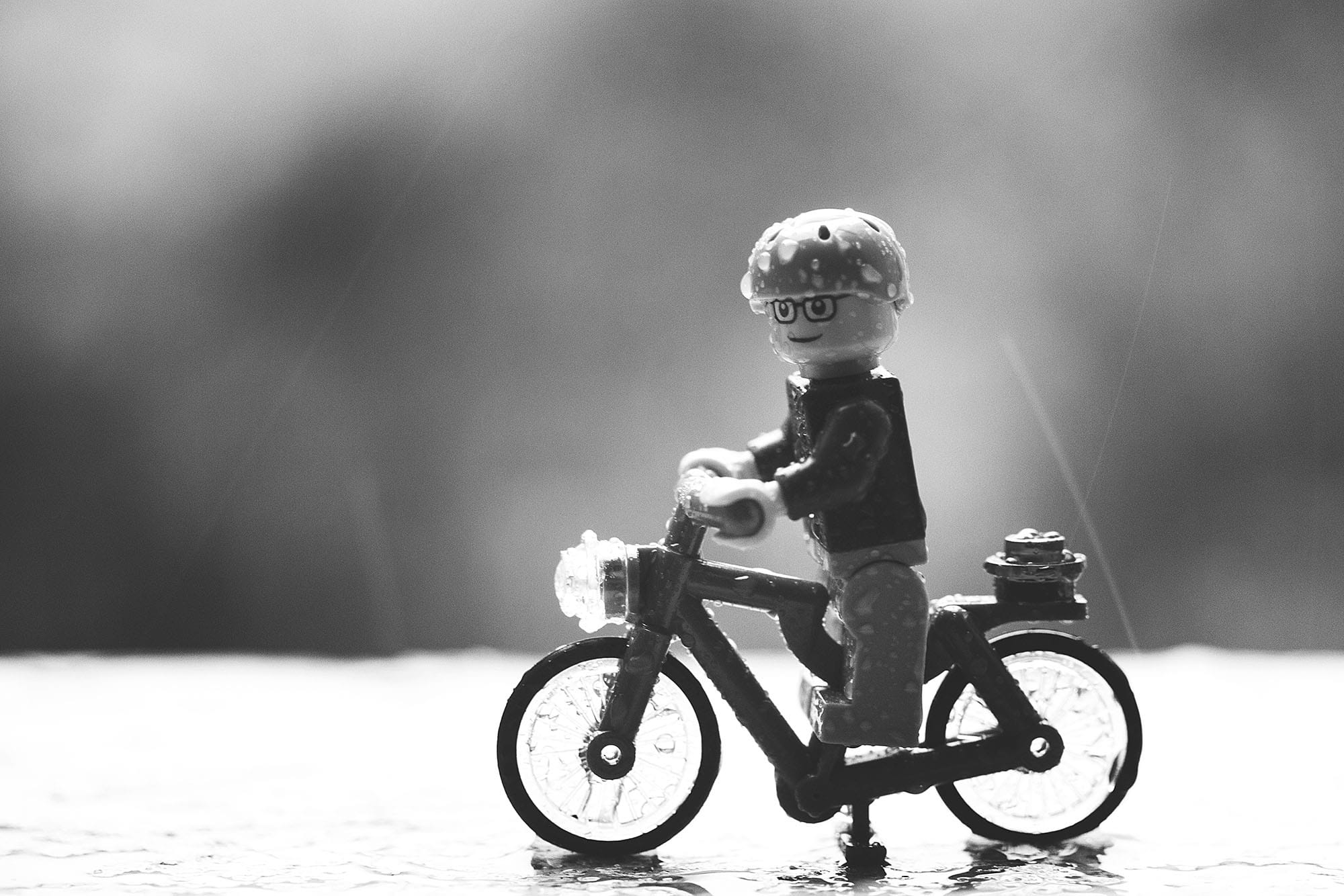 A lego figurine on a bicycle