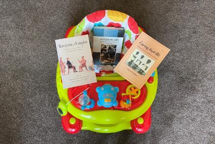 Photo of child's toy and academic books