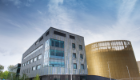 A low angled shot of the Queen Elizabeth University Hospital with bright blue sky above