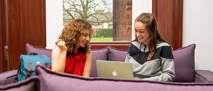 Students looking at a laptop