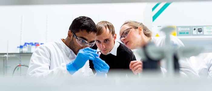 three scientists in a lab 