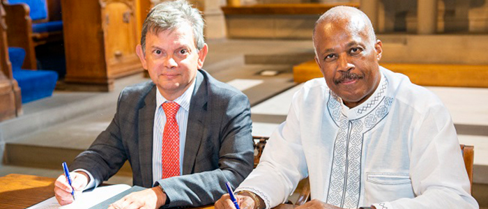Professor Sir Anton Muscatelli and Professor Sir Hilary Beckles signing the MoU