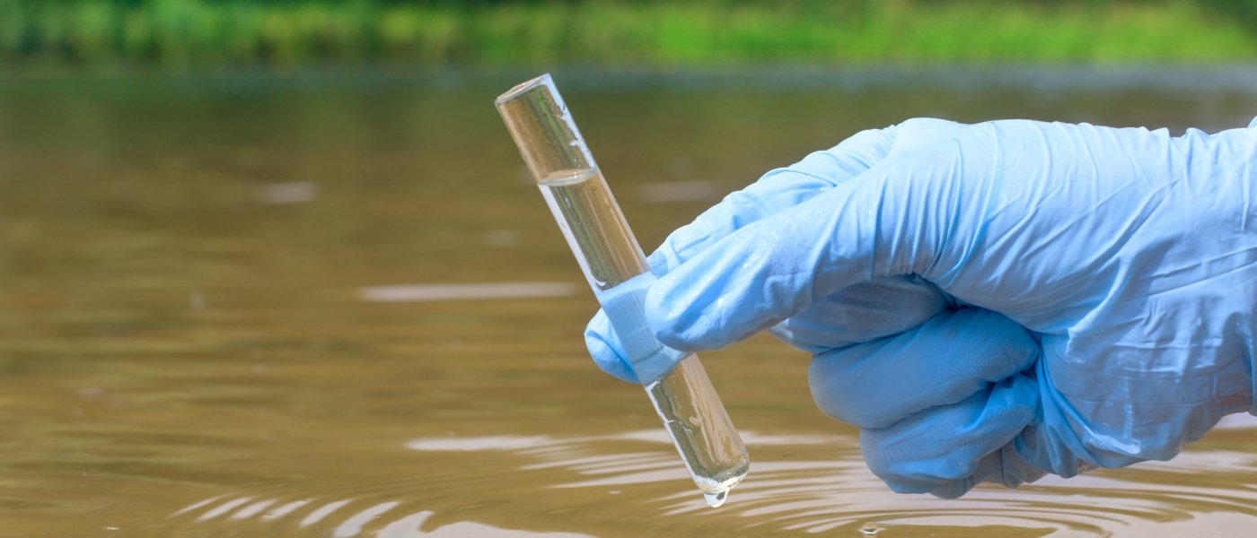 taking a sample of river water