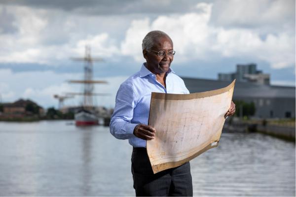 Professor Sir Geoff Palmer, Jamaica’s first Honorary Consul in Scotland, viewing a drawing of the ship Jamaica next to the River Clyde