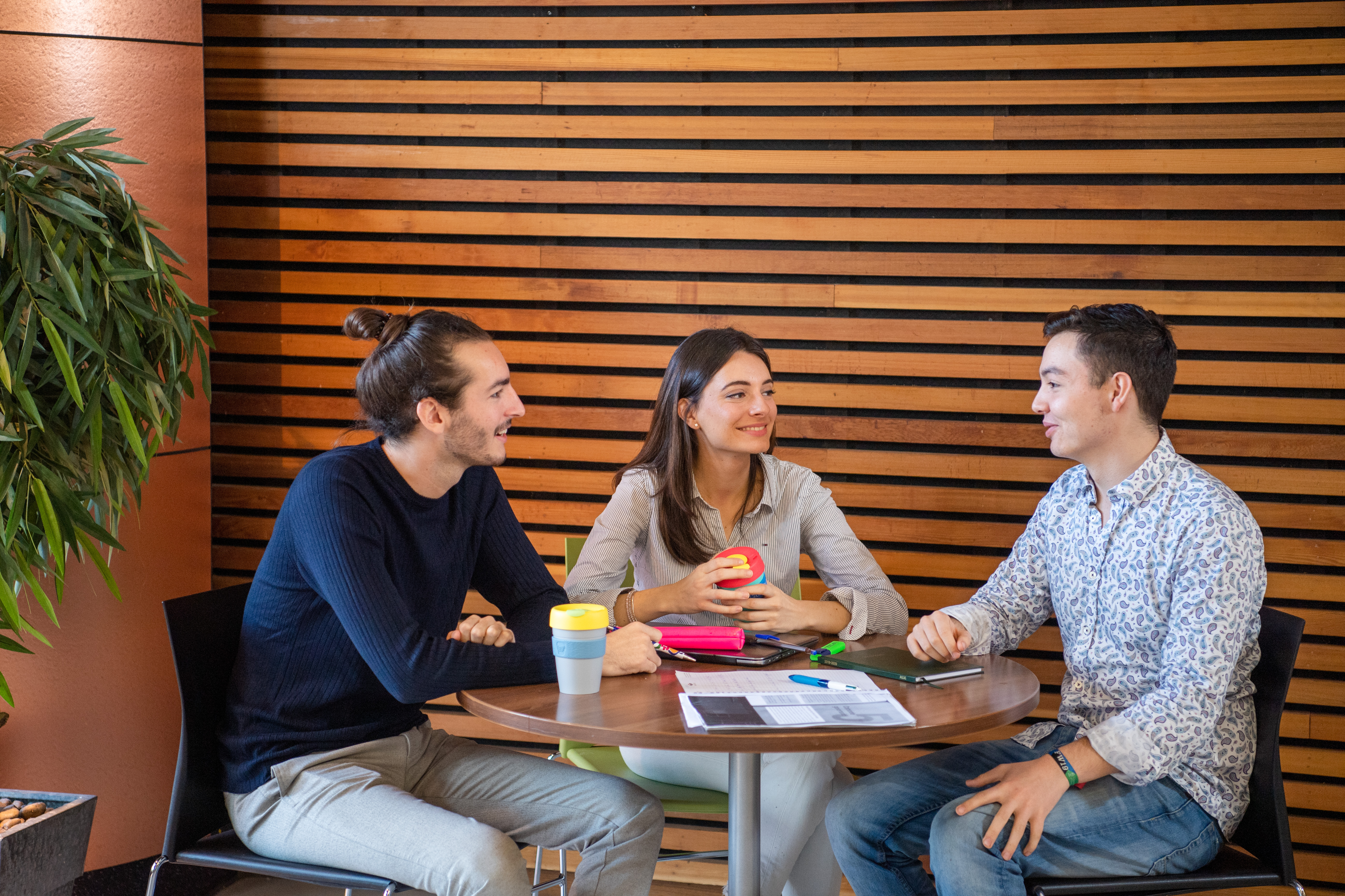 Three students at a table in the library