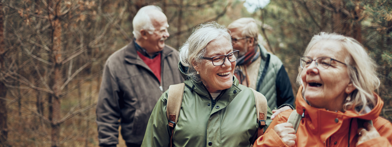 A group of older people walking outdoors 