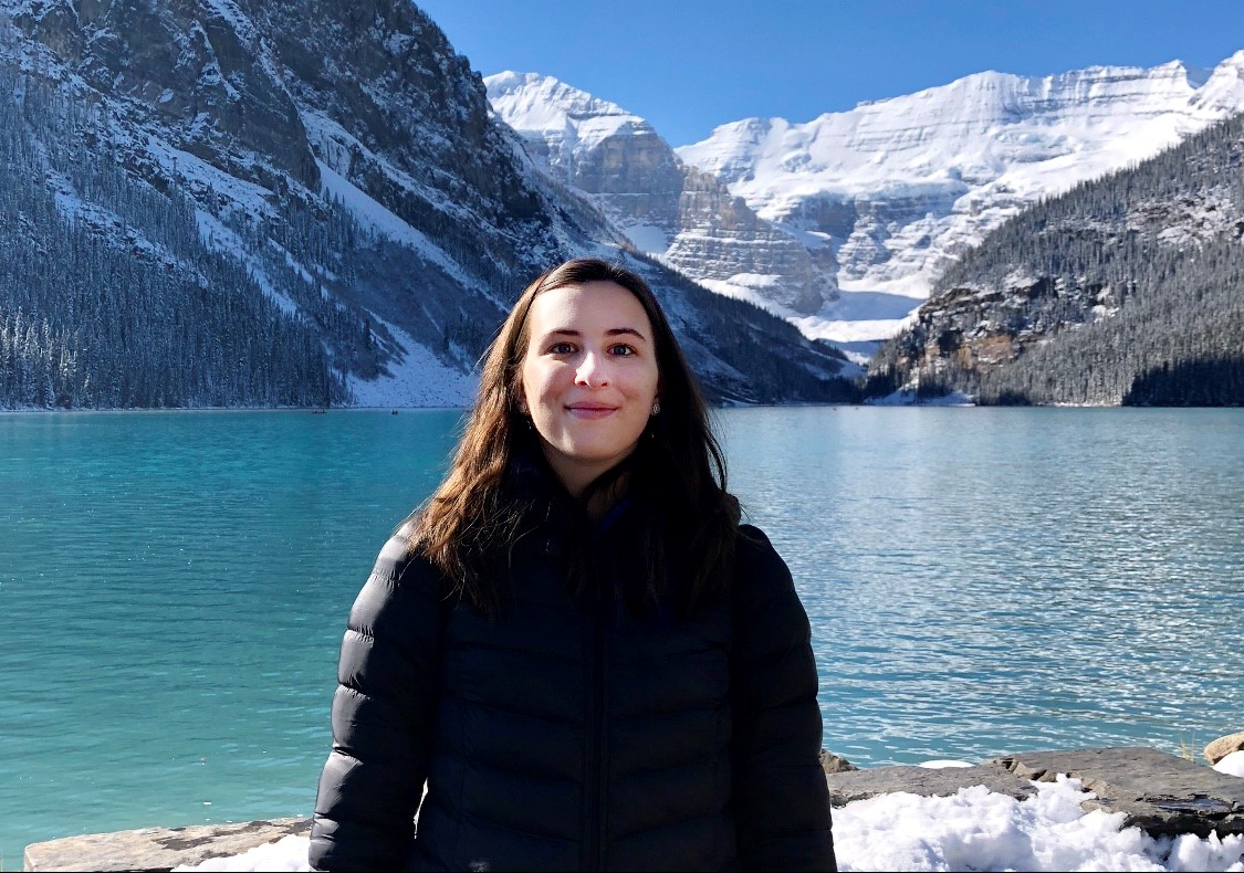 Student stood in front of majestic mountains at Lake Louise, Banff National Park, Alberta, Canada.