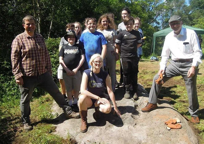 A group photograph of the Clydebank Archaeology Club, team members, and Gil Paterson MSP during excavations at Auchnacraig 1 and 3 in summer 2019.