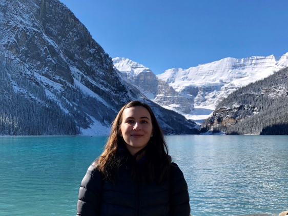 Student stood in front of majestic mountains at Lake Louise, Banff National Park, Alberta, Canada.