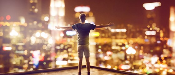 Student looking at night skyline