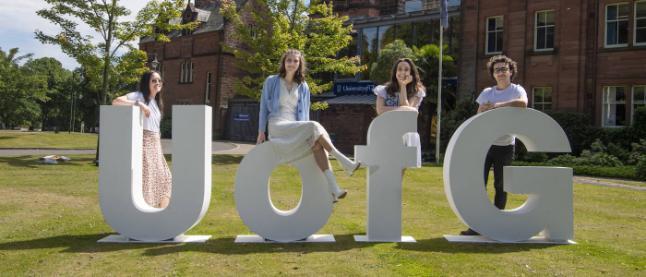 Students at Dumfries campus with UofG sign