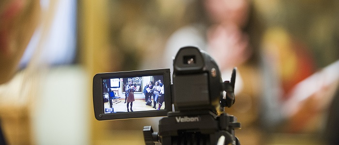 A close up of a film camera recording an event