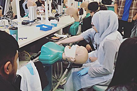 group of school students getting hands on dental learning experience