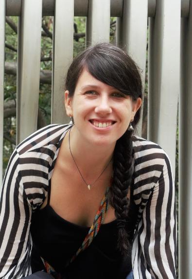 Image of UofG student Victoria Bolton, wearing a black and white stripy shirt and smiling into the camera