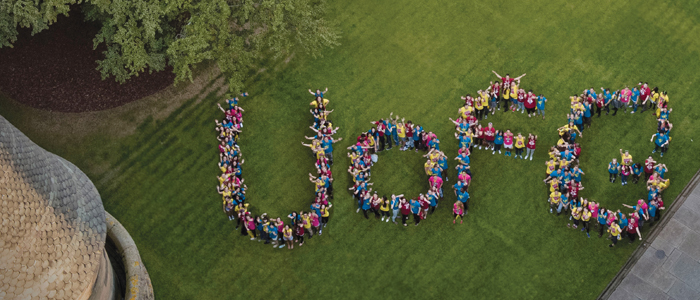 Image from above of people grouped together to spell UofG on the University quadrant grass