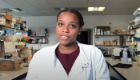 PhD student Kristyn Carter in the lab addressing the camera for a Black History Month UK 2020 vlog