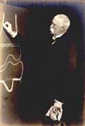 Sir William Macewen writing on a blackboard, courtesy of Medical Illustration, Glasgow Royal Infirmary