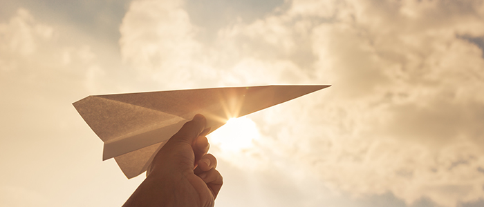 Image of a paper airplane against the sky