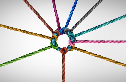 Multicoloured ropes coming together in the middle to form a circle