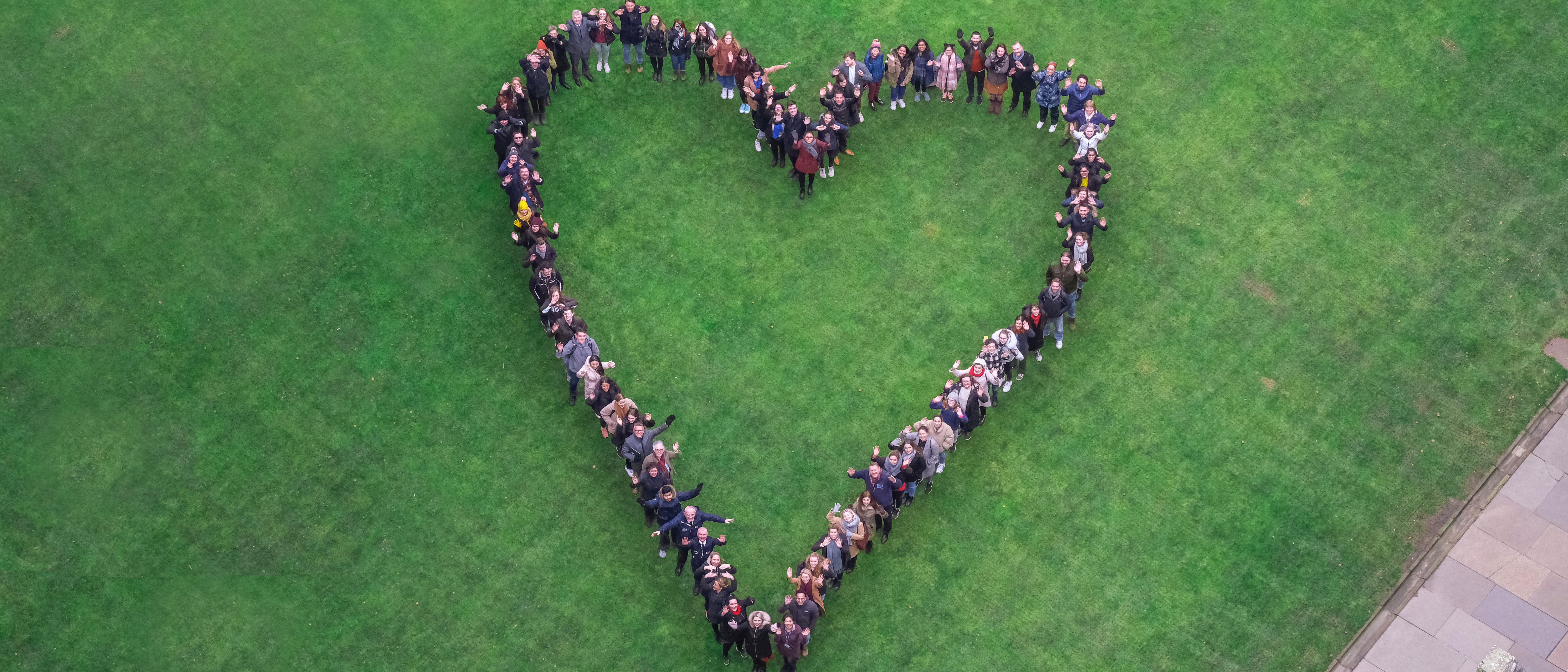 Heart made up of people standing in quad