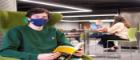 Student wearing a face covering in the library 
