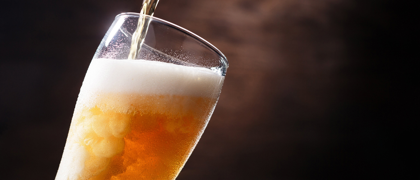 Photo of glass of beer being poured