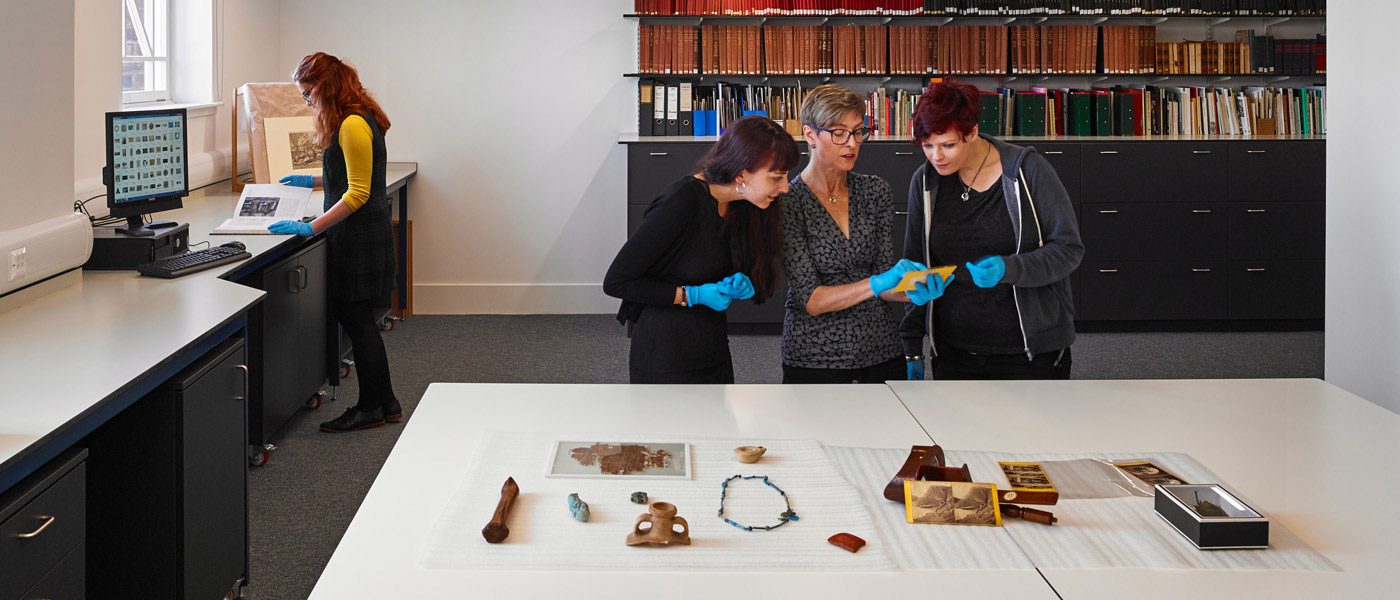researchers at work with table of artefacts