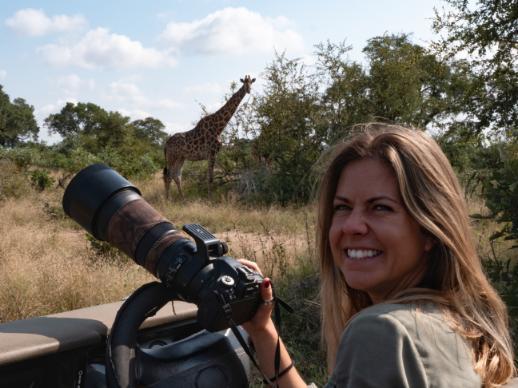 Lauren taking a photograph of a giraffe